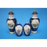 A pair of Crescent china vases with hand painted landscapes, on cobalt blue ground and a pair of