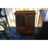 A small mahogany wall cabinet