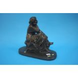 A bronze figure of a contemplating female figure