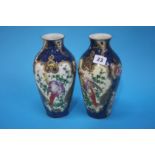 A pair of Royal Worcester vases decorated with bir