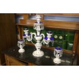 A glass candelabra and pair of matching candle sticks