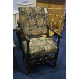 A carved walnut armchair, with upholstered back and seat, carved with figure heads and lions heads