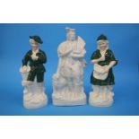An unpainted Staffordshire flat black figure and a pair of figures (3)