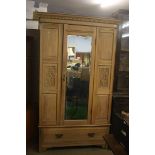 An Edwardian mirror door wardrobe