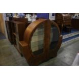 An Art Deco walnut circular design china cabinet. 132cm wide