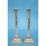 A pair of good quality Corinthian column candle sticks, decorated with swags, acanthus scrolls etc.