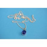 An 18ct white gold pendant and chain set with tanzanite and small diamonds. Tanzanite weight approx.