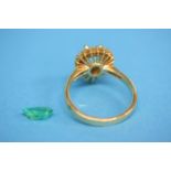 A gold ring set with a central emerald (loose) and surrounded by diamonds (cost £1500)