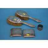 Pair of silver backed brushes, a cigar case and a