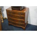 A reproduction mahogany serpentine fronted chest of drawers. 74cm wide