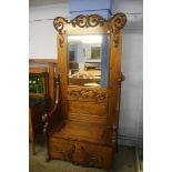 An oak carved mirror back hallstand