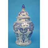 A large blue and white Oriental vase and cover