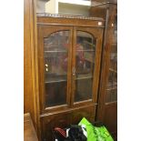 A smaller oak two door bookcase