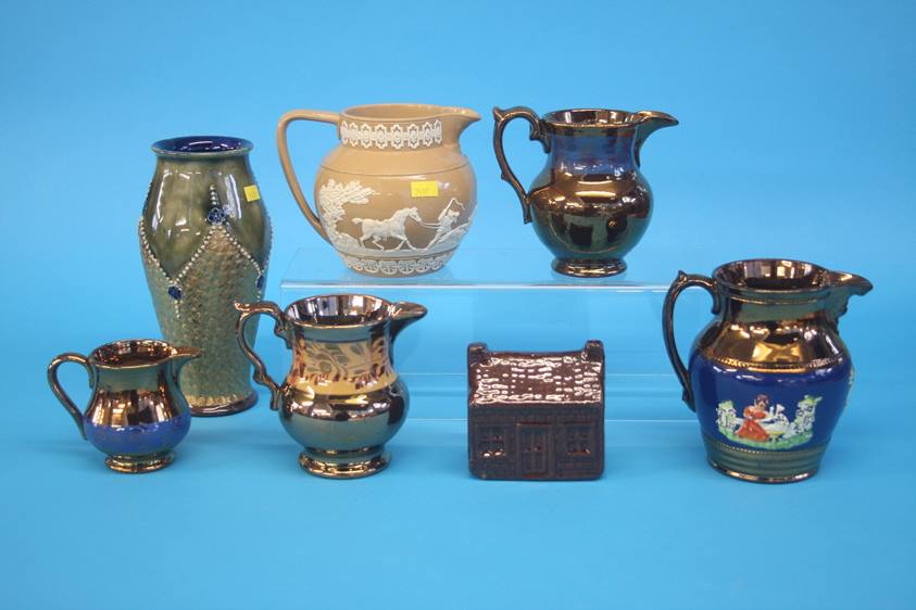 Four copper lustre jugs, a Royal Doulton vase, a late Spode jug and a treacle glaze money box (7)