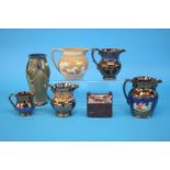 Four copper lustre jugs, a Royal Doulton vase, a late Spode jug and a treacle glaze money box (7)