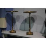 A pair of brass pedestal occasional tables