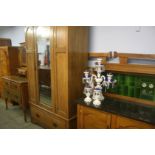 An oak bedroom suite comprising; wardrobe, marble top washstand, dressing chest and bed end
