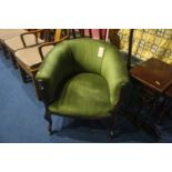 A green upholstered tub chair