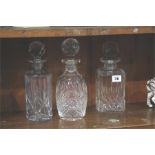 Three cut glass decanters