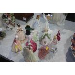 Collection of twelve Royal Doulton and other figur