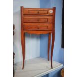A pair of three drawer bedside tables