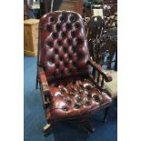 A burgundy leather button back Chesterfield office