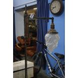 A Liberty style wrought iron standard lamp with wh