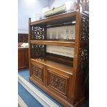 A Mahogany three tier buffet with four carved pane