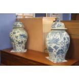 A large pair of Oriental blue and white lidded vas
