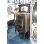 An Edwardian mahogany bow front glazed cabinet