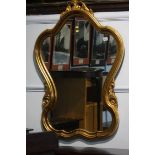 An ornate gilt framed mirror