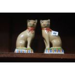 A pair of Staffordshire style cats