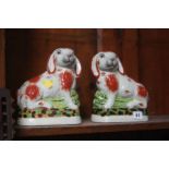 A pair of Staffordshire style rabbits