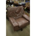 A large Danish leather swivel armchair