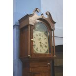 An oak cased 30 hour long case clock, swan neck pediment and painted dial