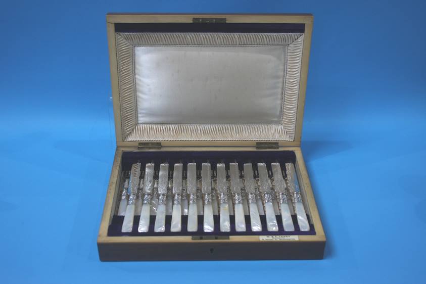 A cased set of twelve fruit knives and forks, with mother of pearl handles