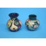 Two small modern Moorcroft vases, decorated with stylised fruit and flowers. 10cm and 8.5cm height