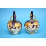 A pair of Royal Crown Derby vases with a single gilt handle, on a cobalt blue ground, decorated with