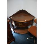 A reproduction mahogany corner washstand