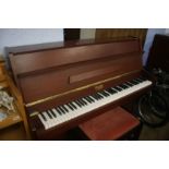 A teak cased Williams upright piano