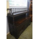 A heavily carved oak buffet sideboard, the central arched panel inscribed 'TDE 1616'