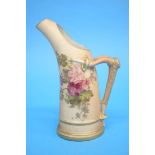 A Royal Worcester tusk jug, decorated with flowers and having a gilt handle, puce marks, numbered