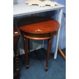 A reproduction mahogany circular occasional table