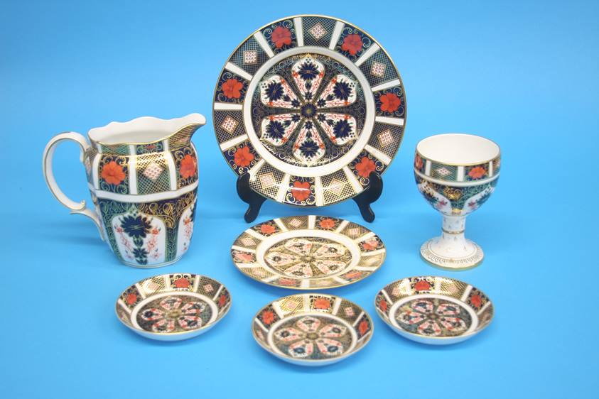 A Royal Crown Derby Imari milk jug, an Imari goblet, three small dishes and two plates. (7)