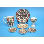 A Royal Crown Derby Imari milk jug, an Imari goblet, three small dishes and two plates. (7)