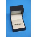 An 18ct white gold diamond ring, set with four diamonds and diamonds to each shoulder (stamped 750),