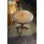 A mahogany snap top tripod table