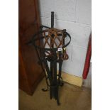 A wrought iron stand and swords etc.