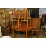 A teak dining table and six chairs