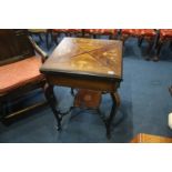 An inlaid Victorian rosewood envelope games table